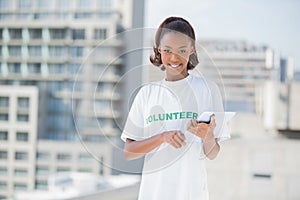 Smiling volunteer holding tablet pc