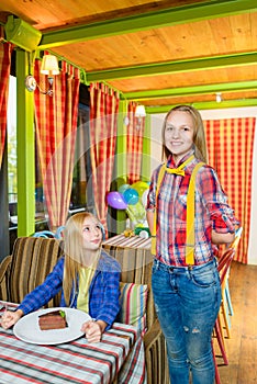 Smiling waiter brought order and dessert to cafe