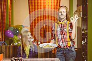 Smiling waiter brought order and dessert to cafe