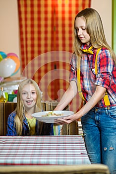 Smiling waiter brought order and salad to cafe