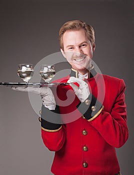 Smiling Waiter in red uniform