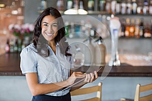 Smiling waitress holding a file