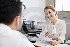 Smiling white female professional in meeting with young man