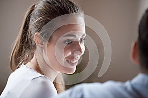 Smiling wife looking at beloved husband with love and care photo