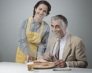 Smiling wife serving dinner