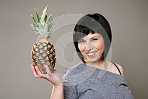 Smiling woman with ananas
