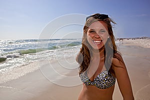 Smiling woman in animal print bikini on beach