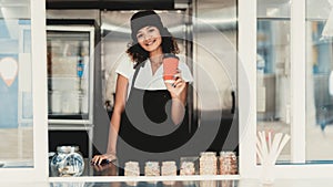 Smiling Woman in Apron Standing in Food Truck.