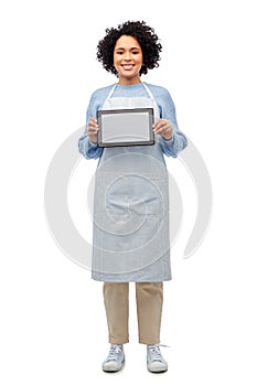 smiling woman in apron with tablet pc computer