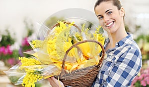 Smiling woman with basket of mimosa spring flowers, 8 March Women`s Day concept