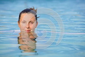 Smiling woman in bathing suit...