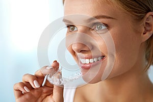 Smiling Woman With Beautiful Smile Using Invisible Teeth Trainer