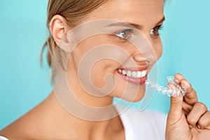 Smiling Woman With Beautiful Smile Using Invisible Teeth Trainer