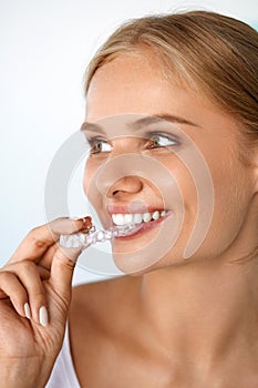 Smiling Woman With Beautiful Smile Using Invisible Teeth Trainer