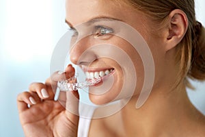 Smiling Woman With Beautiful Smile Using Invisible Teeth Trainer