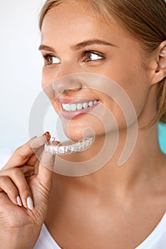 Smiling Woman With Beautiful Smile Using Teeth Whitening Tray