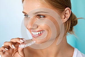 Smiling Woman With Beautiful Smile Using Teeth Whitening Tray