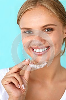 Smiling Woman With Beautiful Smile Using Teeth Whitening Tray