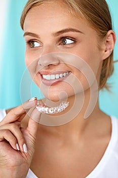 Smiling Woman With Beautiful Smile Using Teeth Whitening Tray