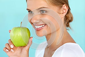Smiling Woman With Beautiful Smile, White Teeth Holding Apple
