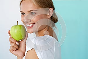 Smiling Woman With Beautiful Smile, White Teeth Holding Apple