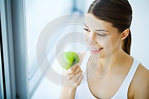 Smiling Woman With Beautiful Smile, White Teeth Holding Apple. H