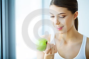 Smiling Woman With Beautiful Smile, White Teeth Holding Apple. H