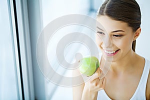 Smiling Woman With Beautiful Smile, White Teeth Holding Apple. H