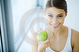 Smiling Woman With Beautiful Smile, White Teeth Holding Apple. H