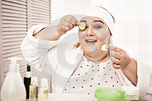 Smiling woman being contented with hand-made beauty hacks