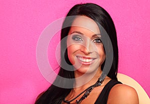 Smiling woman with bijouterie sits on chair