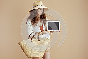 smiling woman in blouse and shorts digital tablet blank screen