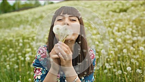 Smiling Woman Blow on a Dandelion