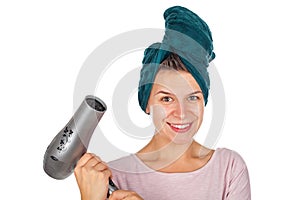 Smiling woman blow drying her hair
