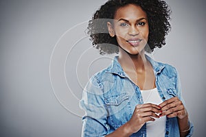 Smiling woman in blue holds hands together