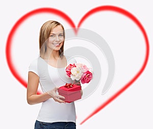 Smiling woman with bouquet of flowers and gift box