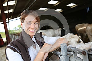 Smiling woman breeder in barn photo