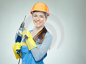 Smiling woman builder wearing protect helmet and uniform holding