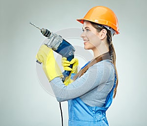 Smiling woman builder wearing protect helmet and uniform holding