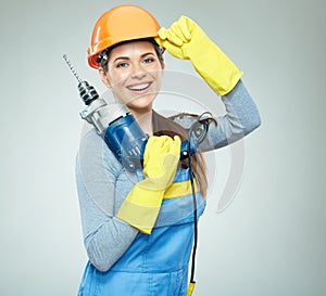 Smiling woman builder wearing protect helmet and uniform holding