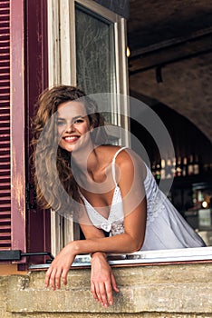 Smiling woman in cafe looking out of window