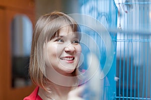 Smiling woman at the cage with pets