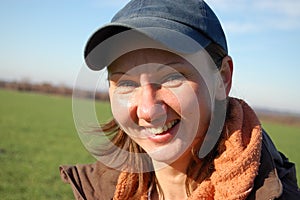 Smiling woman in cap. Outdoors