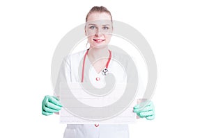 Smiling woman cardiologist in white coat with stethoscope holding electrocardiogram