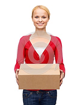 Smiling woman in casual clothes with parcel box