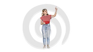 Smiling woman in casual clothes presenting something, pushing imaginary buttons on white background.