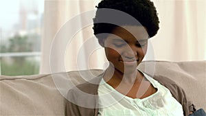 Smiling woman checking her blood pressure