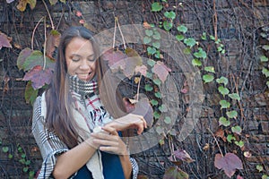 Smiling woman checking time on her wrist watch outside