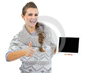 Smiling woman in christmas hat with tablet pc blank screen