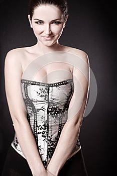 Smiling woman with cleavage in a corset
